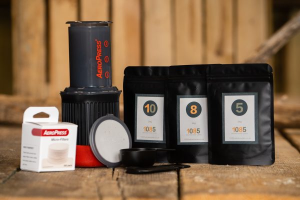 a portable coffee maker and bags of 1085 Snowdonia Coffi 8 from 1085 Adventures.